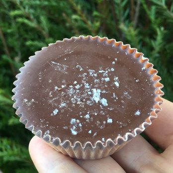 Manzanita Sweets - a hand holding a piece of chocolate - Candy Stores Near Me - Manzanita, Oregon Manzanita Sweets - a hand holding a piece of chocolate - Candy Stores Near Me - Manzanita, Oregon
