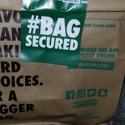a brown bag with a green tag on it