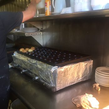 Solvang Restaurant - Employee making aebelskivers - Scandinavian Near Me - Solvang, California Solvang Restaurant - Employee making aebelskivers - Scandinavian Near Me - Solvang, California