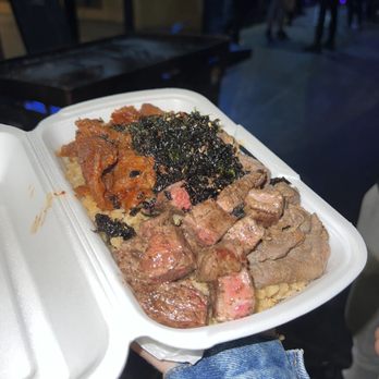 Hussle Hibachi - a person holding a tray of food - Teppanyaki Near Me - Los Angeles, California Hussle Hibachi - a person holding a tray of food - Teppanyaki Near Me - Los Angeles, California