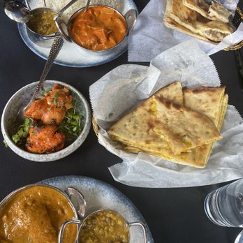 Neer - Modern Indian Dining - Chicken Masala and Chicken Korma with garlic naan and onion stuffed naan with a tandoori chicken appetizer - Indian Near Me - Madison, New Jersey