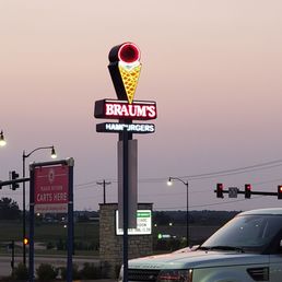 a car parked in front of the sign