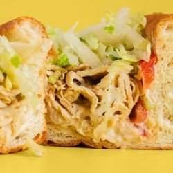 Queen City Cheesesteaks - Chicken Cheesesteak Hoagie served with Grilled Chicken, Fried Onions, Melted Cheese, Lettuce, Tomato, and Mayo