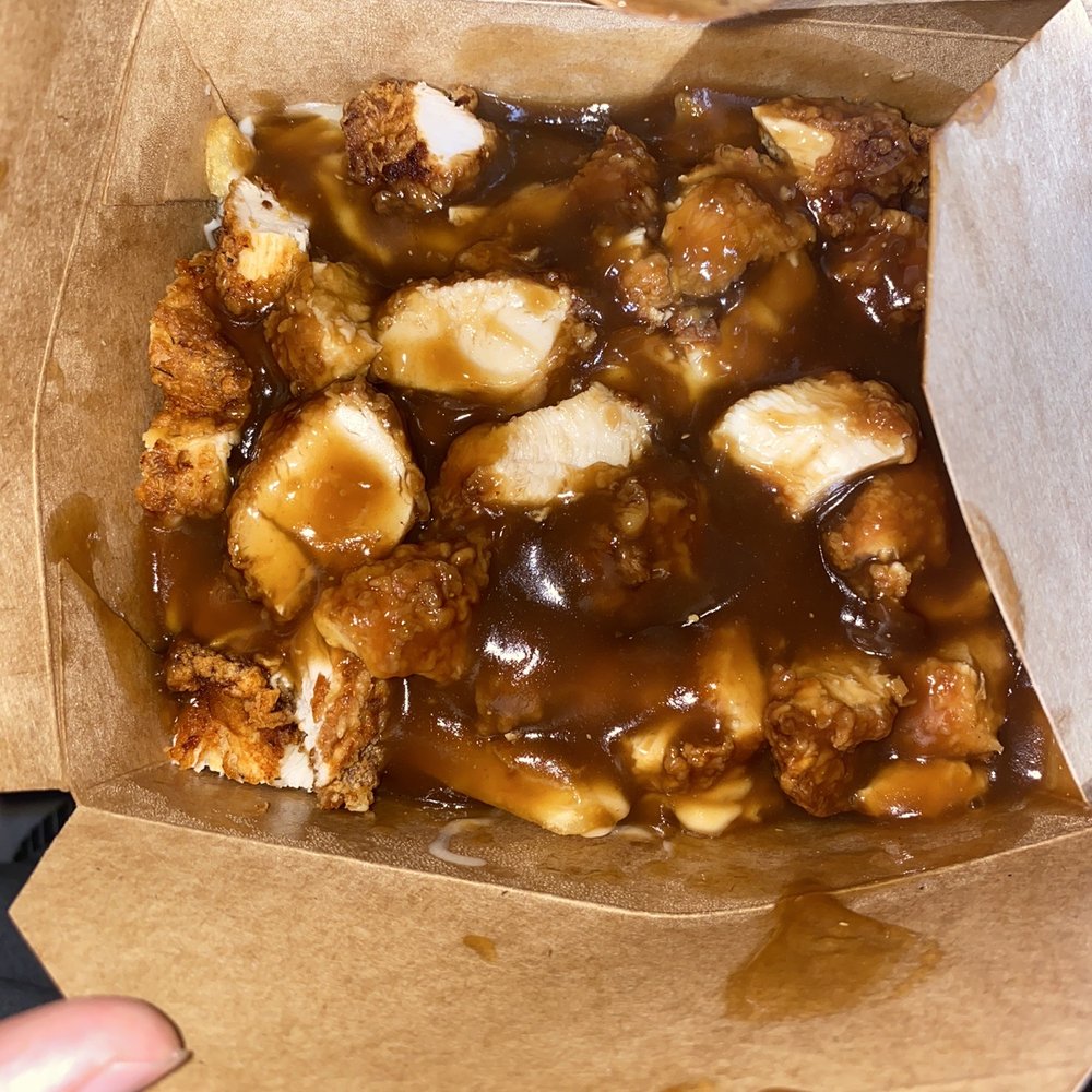 Tasty - a person holding a box of food - Fast Food Near Me - Montreal, Quebec