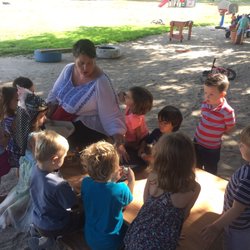 A Little Patch of Earth - Sally taking the eggs they harvested from the on-site chickens and teaching the kids how to crack them!