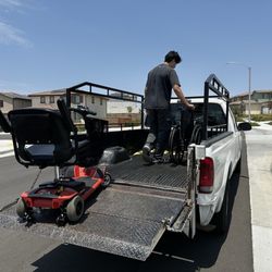 Active Mobility - Scooter and wheelchairs we rented. Gentleman is loading them for return in front of my house.