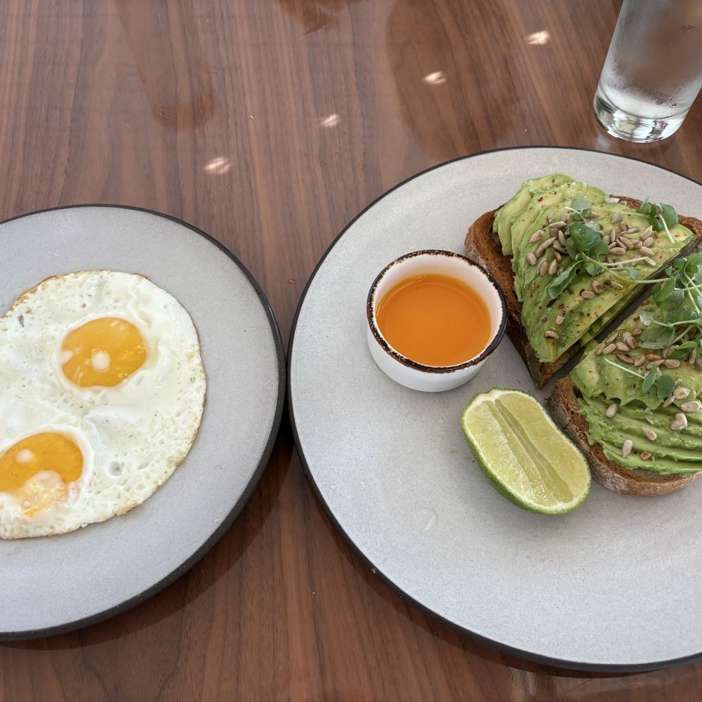 Market at EDITION - Avocado Toast with Chili, Cumin on Seven Grain Bread and 2 eggs sunny side up - Coffee & Tea Near Me - Miami Beach, Florida Market at EDITION - Avocado Toast with Chili, Cumin on Seven Grain Bread and 2 eggs sunny side up - Coffee & Tea Near Me - Miami Beach, Florida