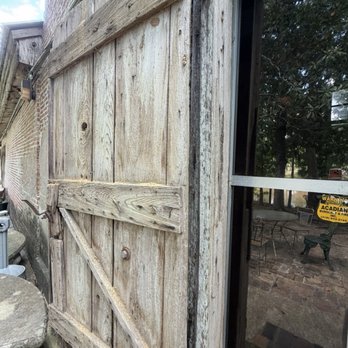 Steamboat Warehouse Restaurant - Old door on back facade, patio area. - Seafood Near Me - Washington, Louisiana
