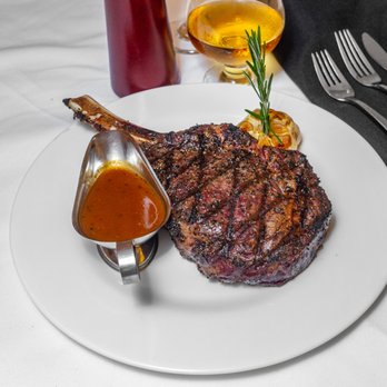 La Brochette - a plate of steak with a side of sauce - Steakhouses Near Me - New York, New York La Brochette - a plate of steak with a side of sauce - Steakhouses Near Me - New York, New York