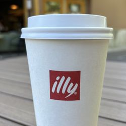 Illy cup on the patio table: illy coffee, "Live Happilly"