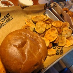 East Coast Wings + Grill - Chicken sandwich, chips, and onion rings