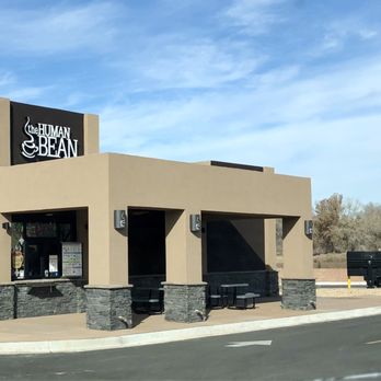 The Human Bean - The Human Bean coffee shop in Los Lunas, NM, features a beige building with black signage, large windows, and outdoor seating areas. - Coffee & Tea Near Me - Los Lunas, New Mexico