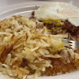 Corned beef hash with hash browns and eggs over easy