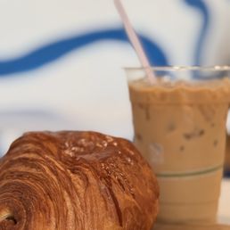 Chocolate croissant and iced vanilla latte Chocolate croissant and iced vanilla latte