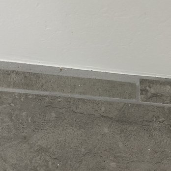 European Builders - poor tile cuts and odd, uneven grout lines - General Contractors Near Me