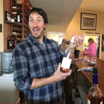 Day Sipper Tours - a man holding a bottle of wine - Breweries Near Me Day Sipper Tours - a man holding a bottle of wine - Breweries Near Me