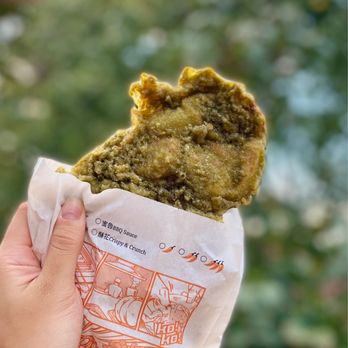Chickaron - a hand holding a piece of food - Chicken Shop Near Me - Toronto, Ontario