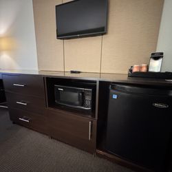 Microwave and fridge in room.