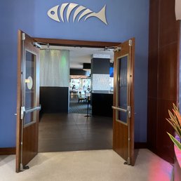 the entrance to a restaurant with a fish sign on the wall the entrance to a restaurant with a fish sign on the wall