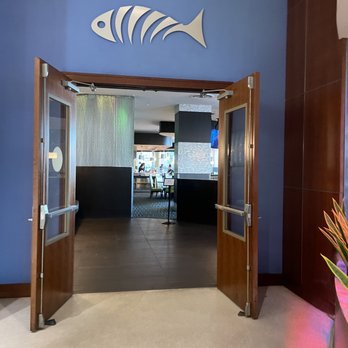 Aqua - the entrance to a restaurant with a fish sign on the wall - Seafood Near Me - Tampa, Florida Aqua - the entrance to a restaurant with a fish sign on the wall - Seafood Near Me - Tampa, Florida