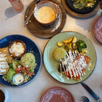 Hacienda Real - Entrees - The table features Mexican cuisine including rice, grilled vegetables, salad, and a creamy soup, along with drinks and dipping sauces. - Seafood Near Me - Vernon Hills, Illinois