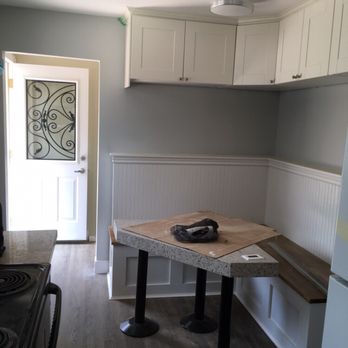 Glenmore Custom Homes - a kitchen with a table and chairs - General Contractors Near Me