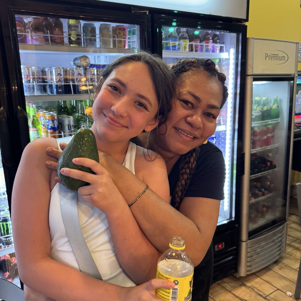 El Chincho - Yoli and my granddaughter with the bonus avocado she gave us to take back to the hotel. - Caribbean Near Me - San Juan, Puerto Rico