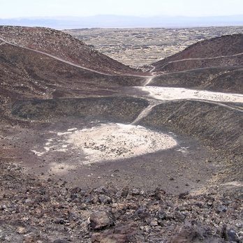 Amboy Crater - Looking into the base of the crater with all the trails made by people exploring this natural feature. - Hiking Near Me - Amboy, California Amboy Crater - Looking into the base of the crater with all the trails made by people exploring this natural feature. - Hiking Near Me - Amboy, California
