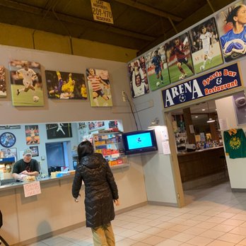 Soccer World - a man and a woman standing in front of a counter - Sports Bars Near Me - Springfield, Illinois