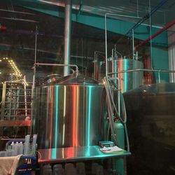 Pondaseta Brewing - Brewery lit up at night.