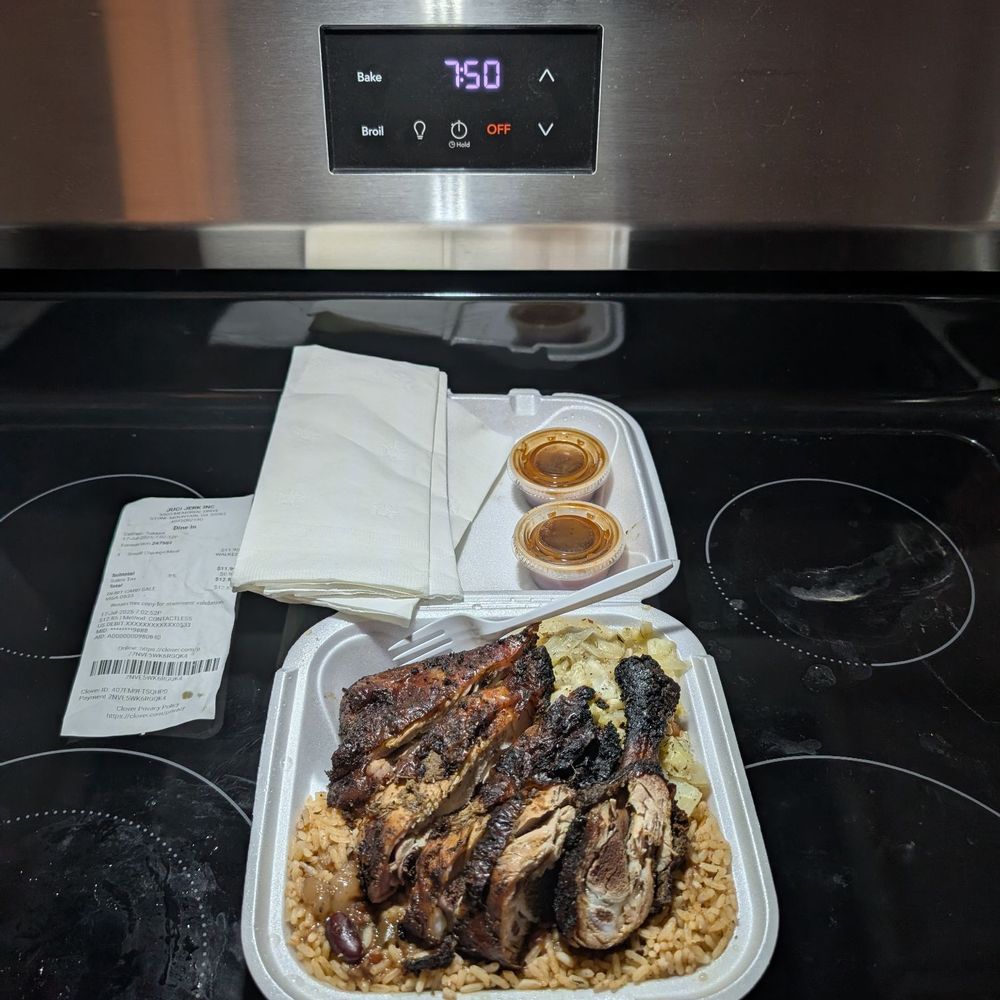 Small jerk chicken plate with rice and peas and cabbage. Small jerk chicken plate with rice and peas and cabbage.