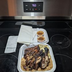 Juci Jerk - Small jerk chicken plate with rice and peas and cabbage.