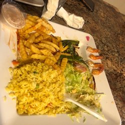 La Sureñita Restaurant - Burnt rice, 4 shrimp and salad. It's not supposed to have the fries , I added those, they charging me extra for that.
