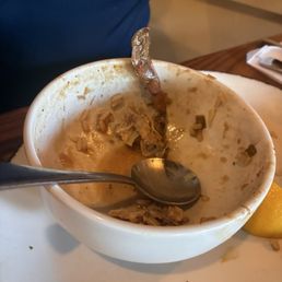 SEAFOOD GUMBO LARGE (after being eaten) with a piece of crab