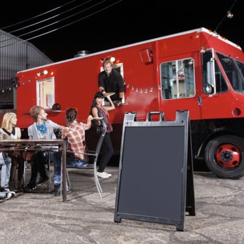 Go-Time Gameland - a group of people sitting at a table in front of a food truck - Game Truck Rental Near Me - Charlotte, North Carolina Go-Time Gameland - a group of people sitting at a table in front of a food truck - Game Truck Rental Near Me - Charlotte, North Carolina