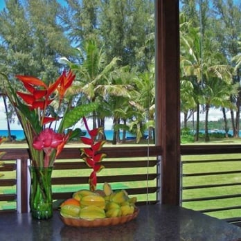 Beach & Bluff Realty - View across the grass to the beach from Hanalei Moon Beach Cottage. - Vacation Rentals Near Me Beach & Bluff Realty - View across the grass to the beach from Hanalei Moon Beach Cottage. - Vacation Rentals Near Me