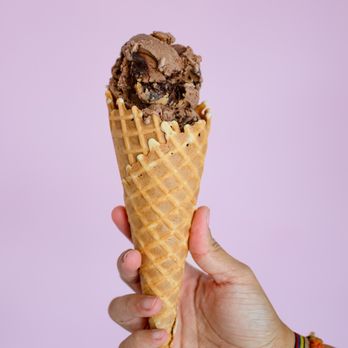 Kelly's Homemade Ice Cream - a hand holding an ice cream cone - Ice Cream & Frozen Yogurt Near Me - Winter Park, Florida Kelly's Homemade Ice Cream - a hand holding an ice cream cone - Ice Cream & Frozen Yogurt Near Me - Winter Park, Florida
