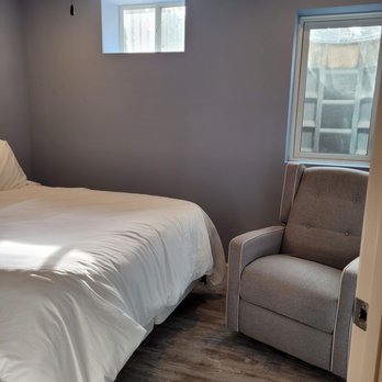 Premier 1 Properties - a bedroom with a chair and a bed - General Contractors Near Me - Saint Peters, Missouri Premier 1 Properties - a bedroom with a chair and a bed - General Contractors Near Me - Saint Peters, Missouri