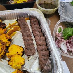 Persian Kabobs - Chicken thigh kabob and chicken breast kabob and kobideh servings with Persian bread and sabzi