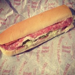 a sub sandwich with meat and lettuce
