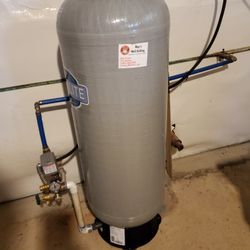 Ray's Well Drilling - Well pump pressure switch and tank with new plumbing and electrical connection.