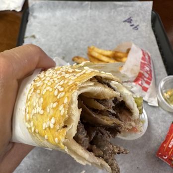 Donerka Shawarma & Cafe - a hand holding a sandwich - Fast Food Near Me - Mount Prospect, Illinois Donerka Shawarma & Cafe - a hand holding a sandwich - Fast Food Near Me - Mount Prospect, Illinois