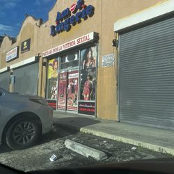 Amor Lingerie - The outside of the shop. There were beer cans and trash littered throughout the parking lot.