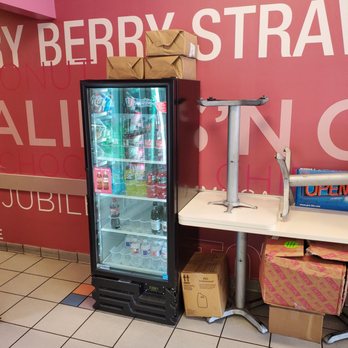 Baskin-Robbins - a refrigerator and a table in a store - Ice Cream & Frozen Yogurt Near Me - Plano, Texas