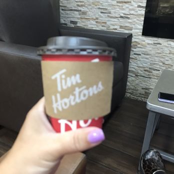 Tim Hortons - a person holding a cup of coffee - Cafes Near Me - Saint Clair Shores, Michigan Tim Hortons - a person holding a cup of coffee - Cafes Near Me - Saint Clair Shores, Michigan