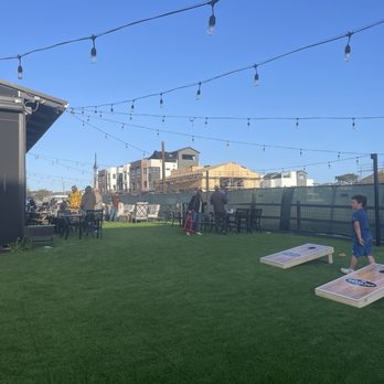 The Brass Tap - Outside with corn hole and connect four - Sports Bars Near Me - Marina, California The Brass Tap - Outside with corn hole and connect four - Sports Bars Near Me - Marina, California