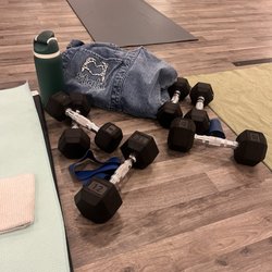 Light weights, resistance band, yoga mat, towel, water