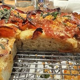 Very thin cheese layer and lots of thick, oily bread.
