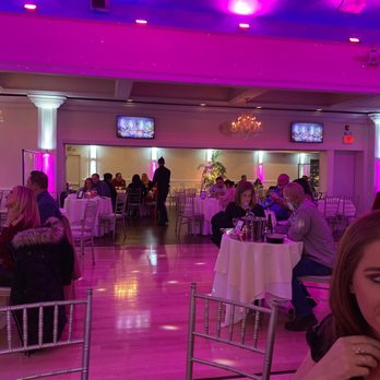 Anthony's Live - a woman eating a slice of pizza - Dinner Theater Near Me - Lake Ronkonkoma, New York