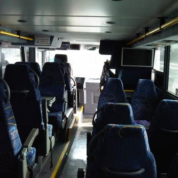 Megabus - bottom level of the double-decker bus, view from the rear. note the two tables with face-to-face seating. - Buses Near Me